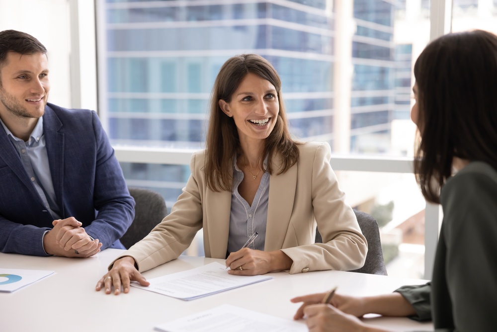 Professional,Middle-aged,Woman,In,Formal,Attire,Sits,At,Conference,Table